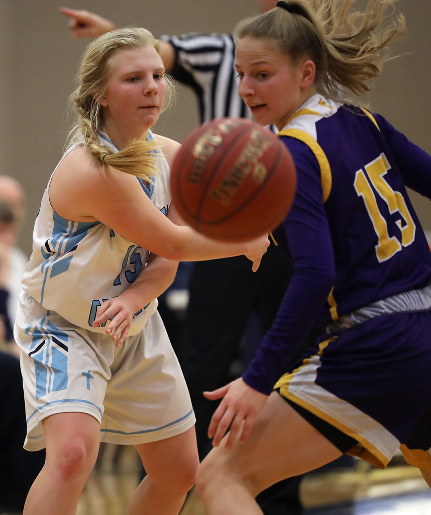 Sophie Angel and Maci Kuchta watch as the ball goes out of bounds